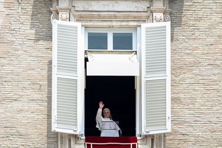 Pope Leo leads the Angelus prayer from a window of