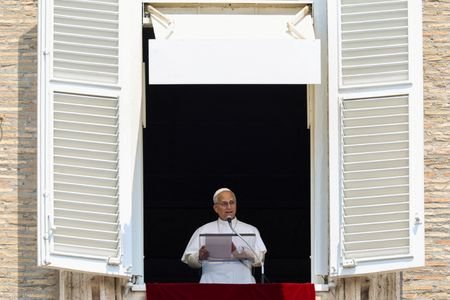 Pope Leo leads the Angelus prayer from a window of