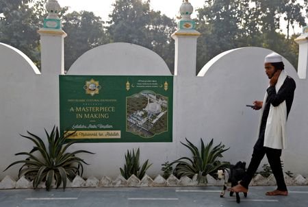 FILE PHOTO: A Muslim man walks his goat at a