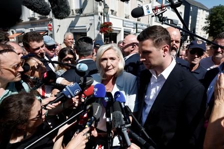 French far-right leaders Le Pen and Bardella visit a market