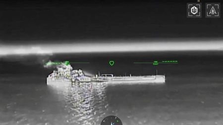 Drone footage shows fire and smoke rising from an oil