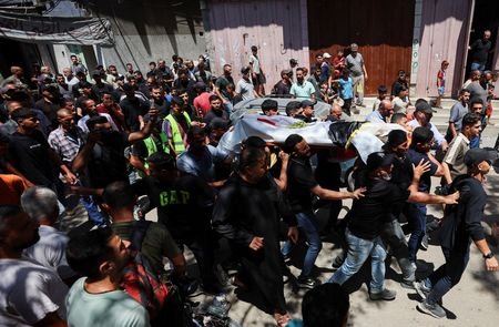 Mourners carry the body of Palestinian man Mohammad al-Waheidi, who