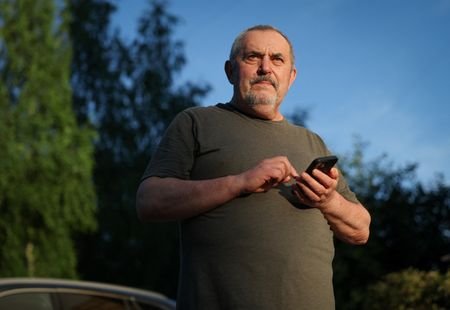 Boris Nadezhdin, an anti-war Russian politician, checks his phone in