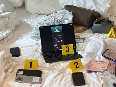 Evidence related to Denis Obrezko lies on a bed, in