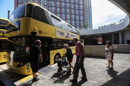 Passengers board a Bee Network bus at Stockport Interchange in