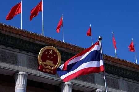 FILE PHOTO: National flags of Thailand and China in Beijing