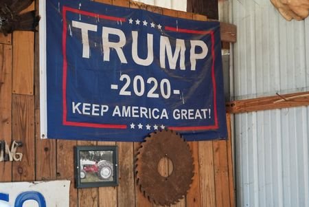 A Trump 2020 flag hangs from a wall inside the
