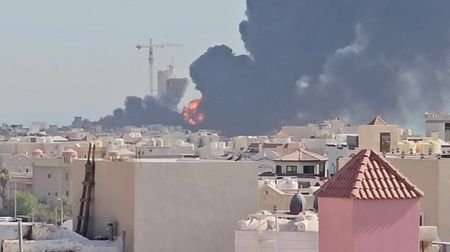 Smoke billows near the oil facility in Mangaf