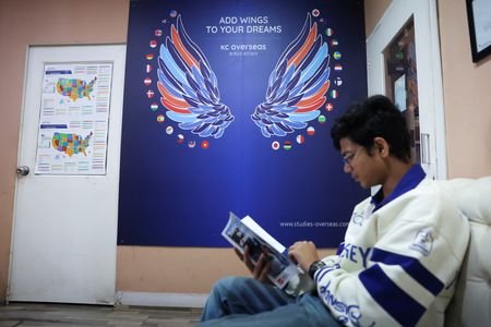 A student reads a brochure next to a study abroad