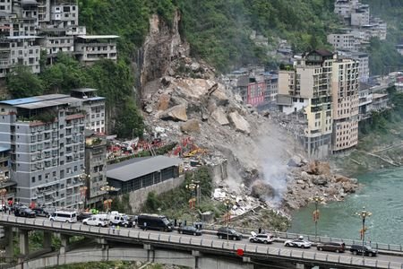 Rescue workers search for survivors at the site of a