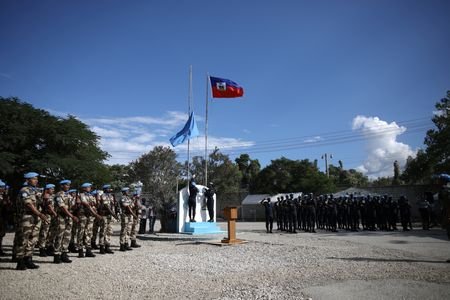 Senegalese officers with the FPU raise a United Nations flag