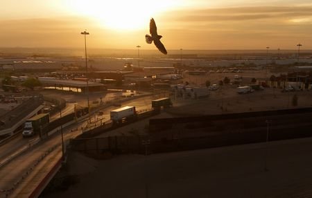 Trucks cross the US-Mexico border on the day U.S. President
