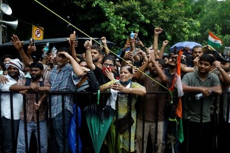 Supporters of India's Cockroach Janta Party (CJP) react at a