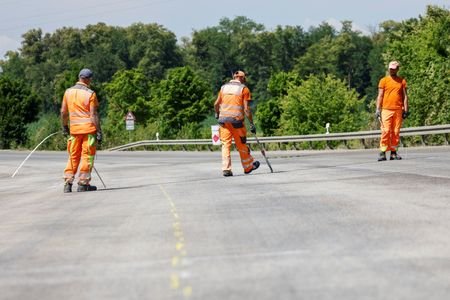 Construction workers mark the road near Germering