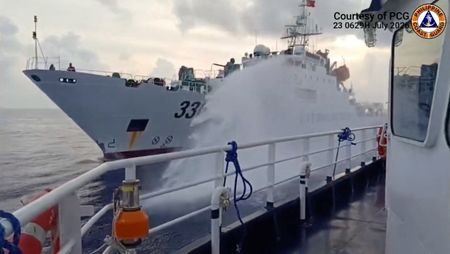 A Chinese coast guard ship fires a water cannon at