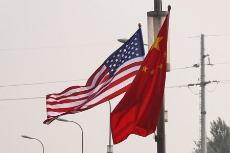 National flags of China and the United States flutter on