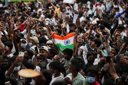 Supporters of India's Cockroach Janta Party (CJP) celebrate after India’s