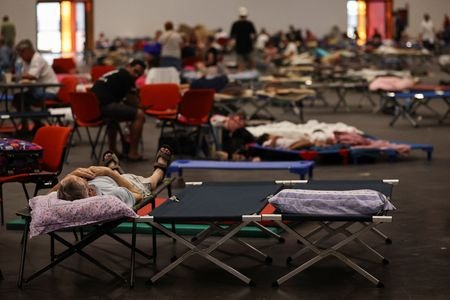 Evacuated residents rest at the Bordeaux-Lac Exhibition Centre, in Bordeaux