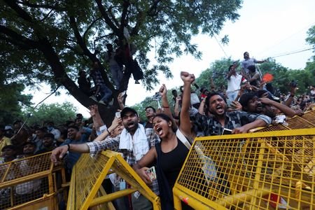 Cockroach Janta Party (CJP) supporters celebrate after the resignation of