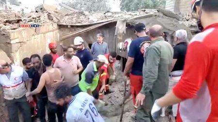 Rescuers clear rubble to search for victims following a strike