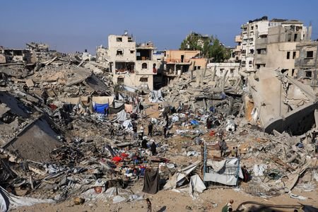 Palestinians inspect the site of Wednesday's Israeli strike on a