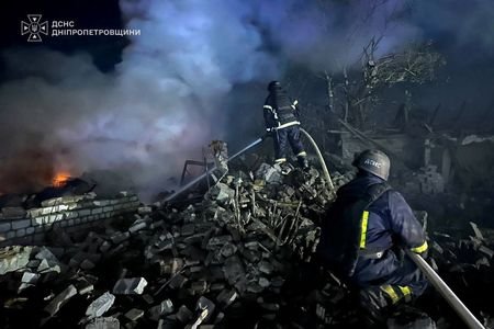 Emergency personnel work following a Russian missile strike at a
