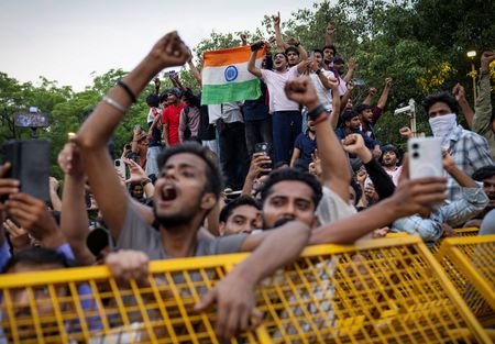 Supporters of India's Cockroach Janta Party (CJP) celebrate after India's
