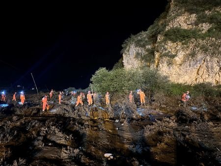 Rescue workers carry out search and rescue operations following flash