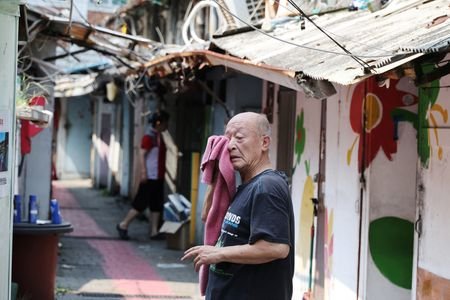 A man wipes off sweat at a jjokbang village which