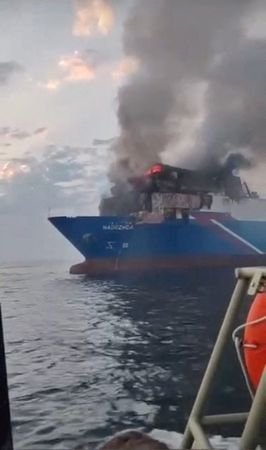 Smoke rises from a fire on the cargo ship Nadezhda