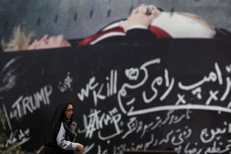 Woman walks past a billboard depicting U.S. President Donald Trump