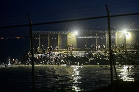 Migrants swim to Spain's Ceuta in mass border crossing