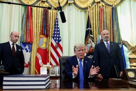 U.S. President Donald Trump signs executive orders at the Oval