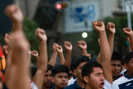 Demonstrators march to demand justice for the disappearance of students