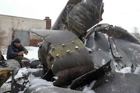 FILE PHOTO: A man photographs parts of an unidentified missile,