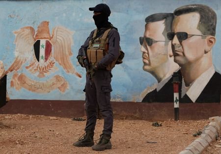 FILE PHOTO: A member of the former rebel group Hayat