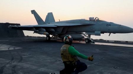 A fighter plane takes off, said to be, for an