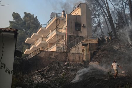 Tourists flee as Greek wildfire descends on resort village in