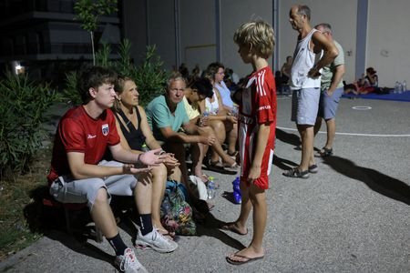 Tourists flee as Greek wildfire descends on resort village in