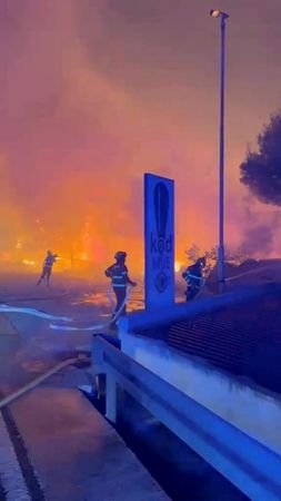 Firefighters work to extinguish a wildfire in Omis