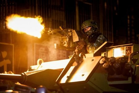 A Taiwanese military member fires ammunition aboard an armoured vehicle