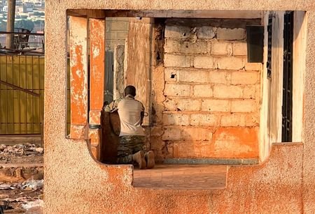 FILE PHOTO: A Malian soldier stands in position with his