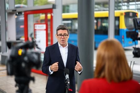 Britain's Prime Minister Andy Burnham visits a bus depot in