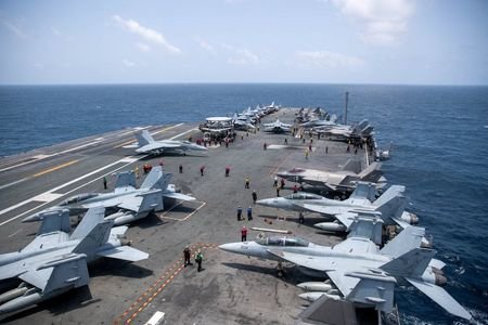 U.S. Navy sailors work on the flight deck of the