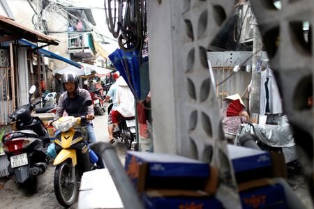 A motorbike is driven in an alley at Ma Lang