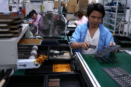 FILE PHOTO: An employee works on an assembly line for