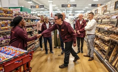 FILE PHOTO: Britain's Prime Minister Andy Burnham talks with staff
