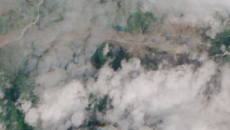 A satellite image shows a barrier lake at the border
