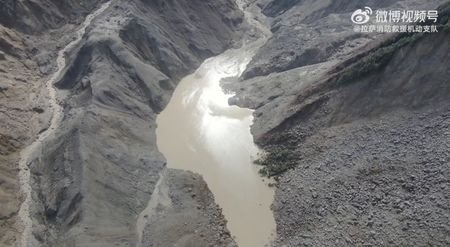 A drone view shows a barrier lake formed following a