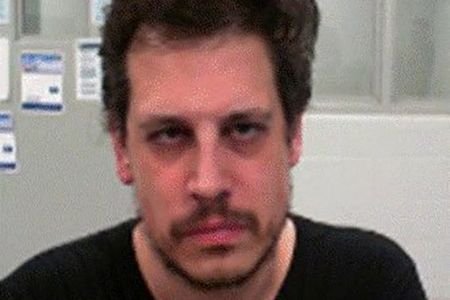 Milo Yiannopoulos poses after his arrest by federal immigration agents
